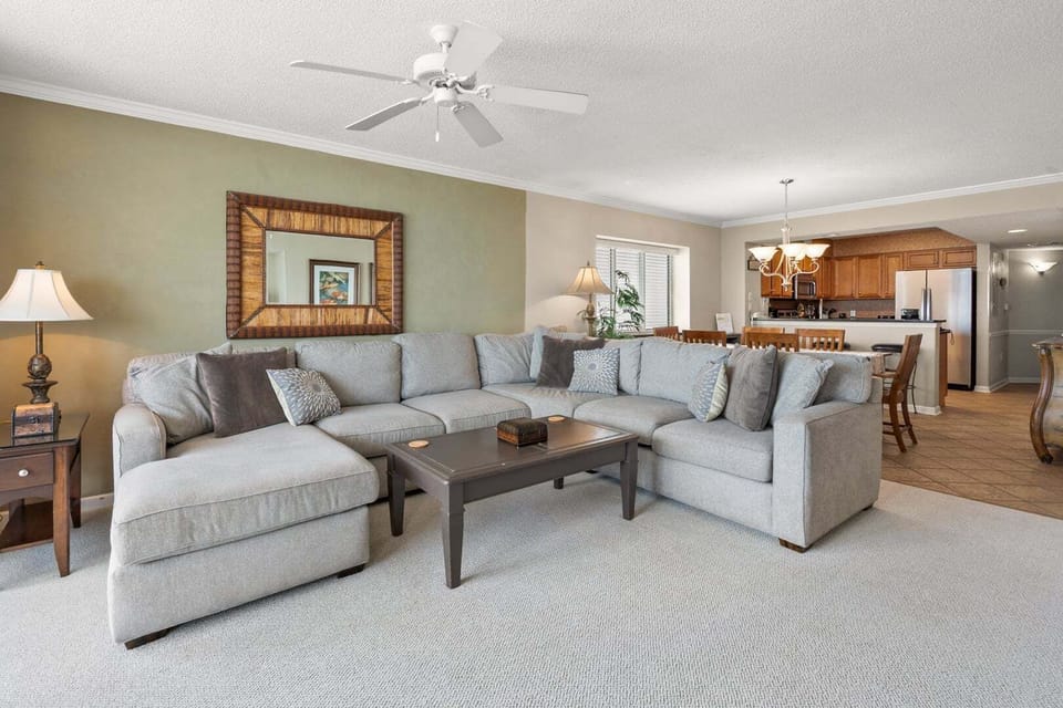 Sofa, mirror and a lamp-lit side table in the living area at South Shore Villas 1207 in Crescent Beach