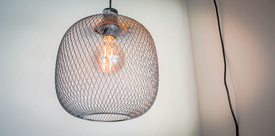 Relax beneath the warm glow of this stylish mesh pendant light that adds contemporary elegance to your space.