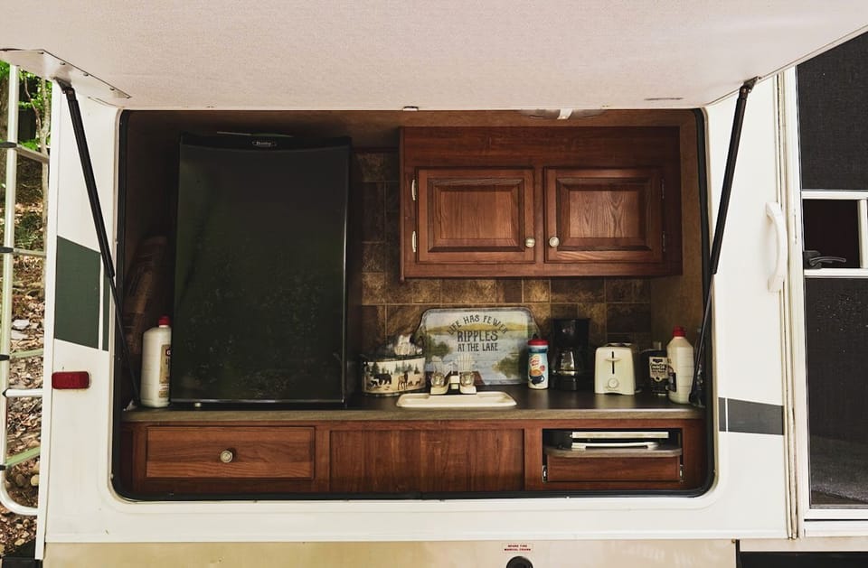 Outdoor small extra kitchen with fridge and sink
