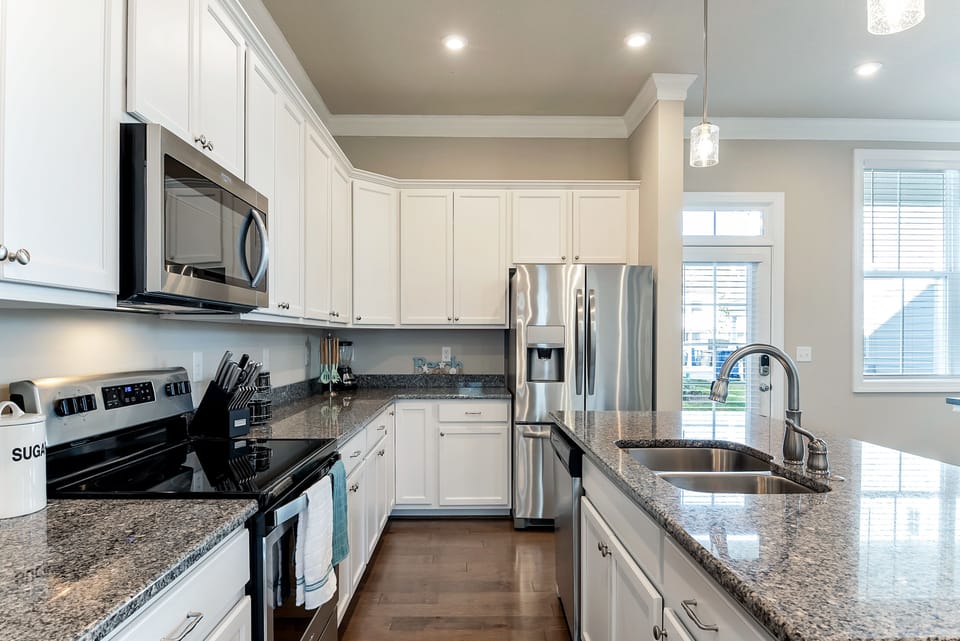 Stainless steel appliances and a large island.