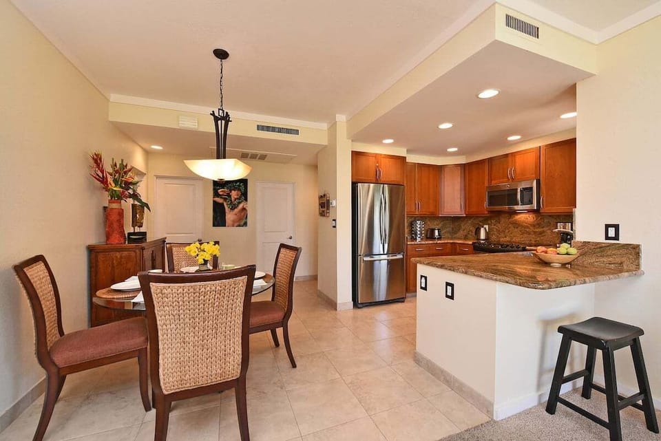 Open‑concept kitchen and dining area with modern finishes and seating.