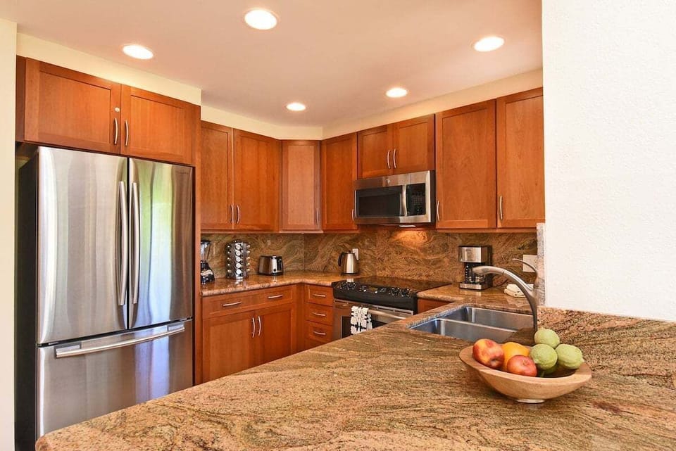 Gourmet kitchen with granite countertops and full stainless‑steel appliances.