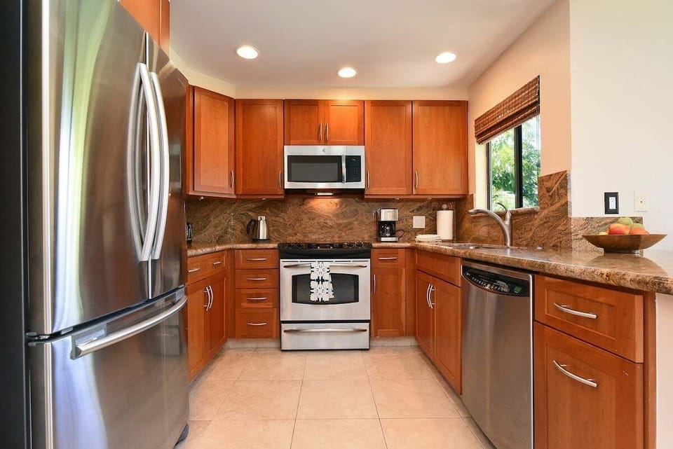 Gourmet kitchen with stainless appliances and granite countertops.