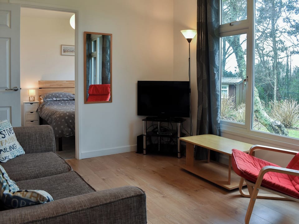 Comfortable living area and adjacent bedroom | Chalet 7 - Mount Hawke Holiday Bungalows, Mount Hawke, near Redruth