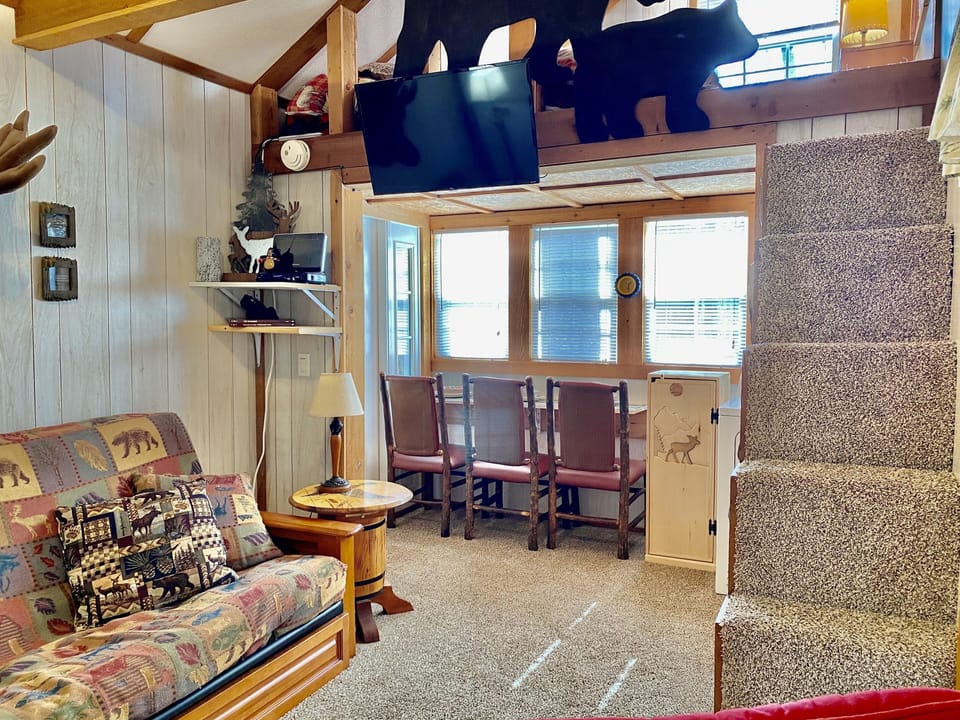 Stairs lead up to loft with Queen bed