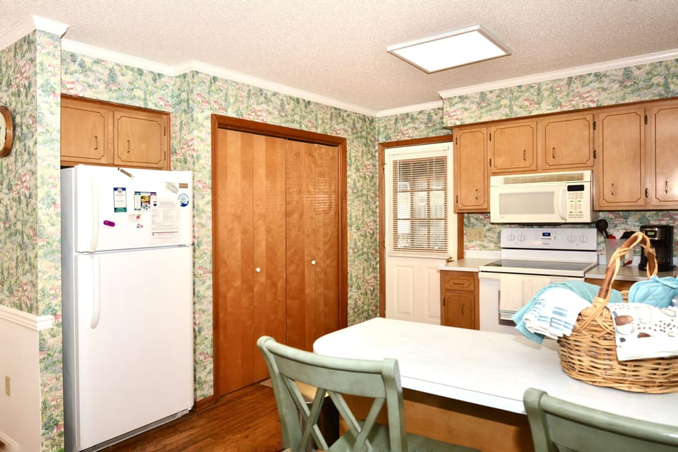 Laundry is located in the kitchen and the door to the screened porch!