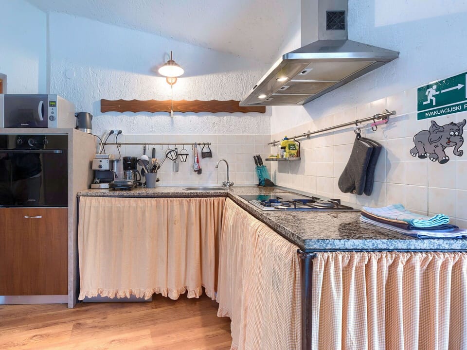 Countertop, Cabinetry, Table, Kitchen, Interior Design, Lighting, Wood, Kitchen Appliance, Kitchen Stove, Floor