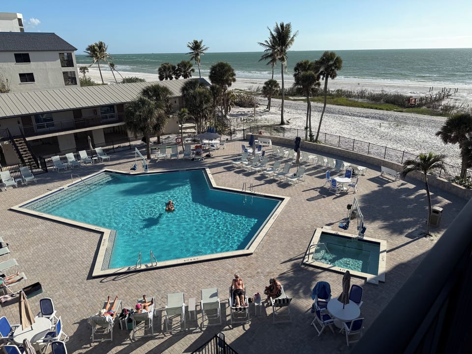 Daytime pool view of heated pool and hot tub amnesties 