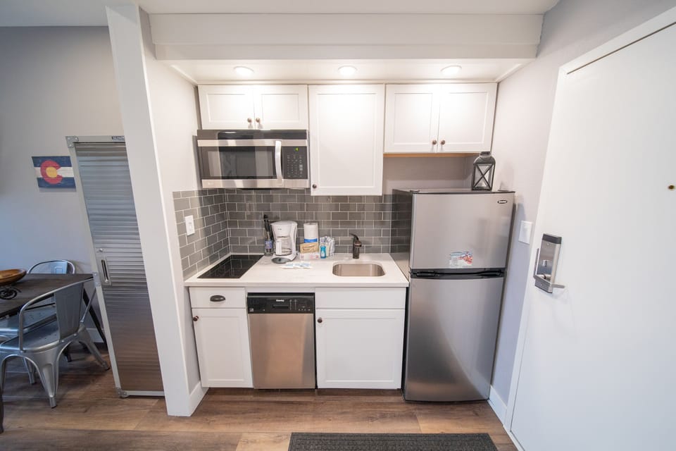 Kitchenette with stove top and refrigerator
