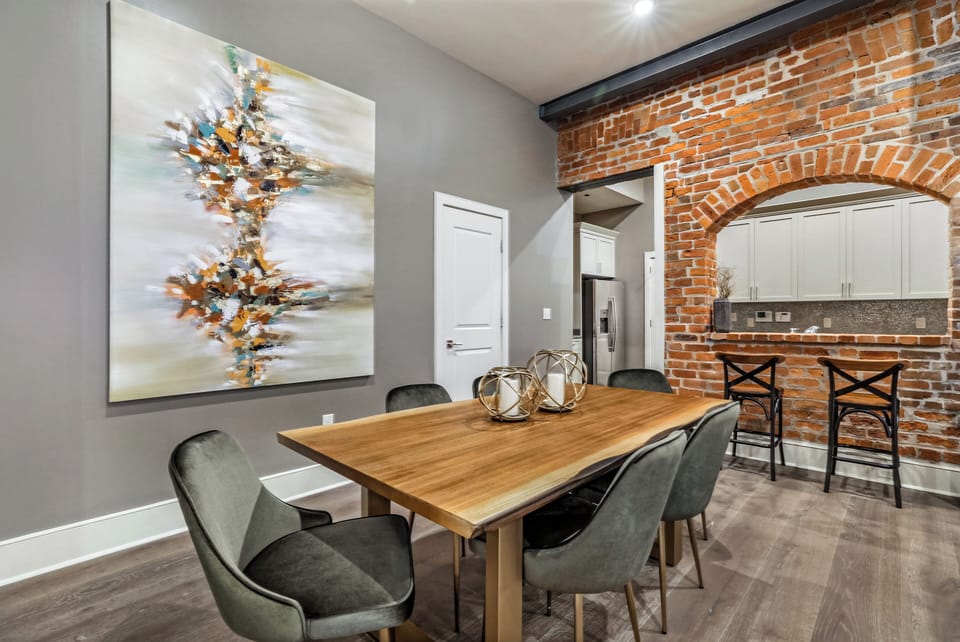 Open-concept living and dining area with ample seating for you and your guests. Relax on the large sectional after a fun-filled day in NOLA! Enjoy a Samsung Smart 4K TV for streaming and DIRECTV Entertainment. Dining table seats six.