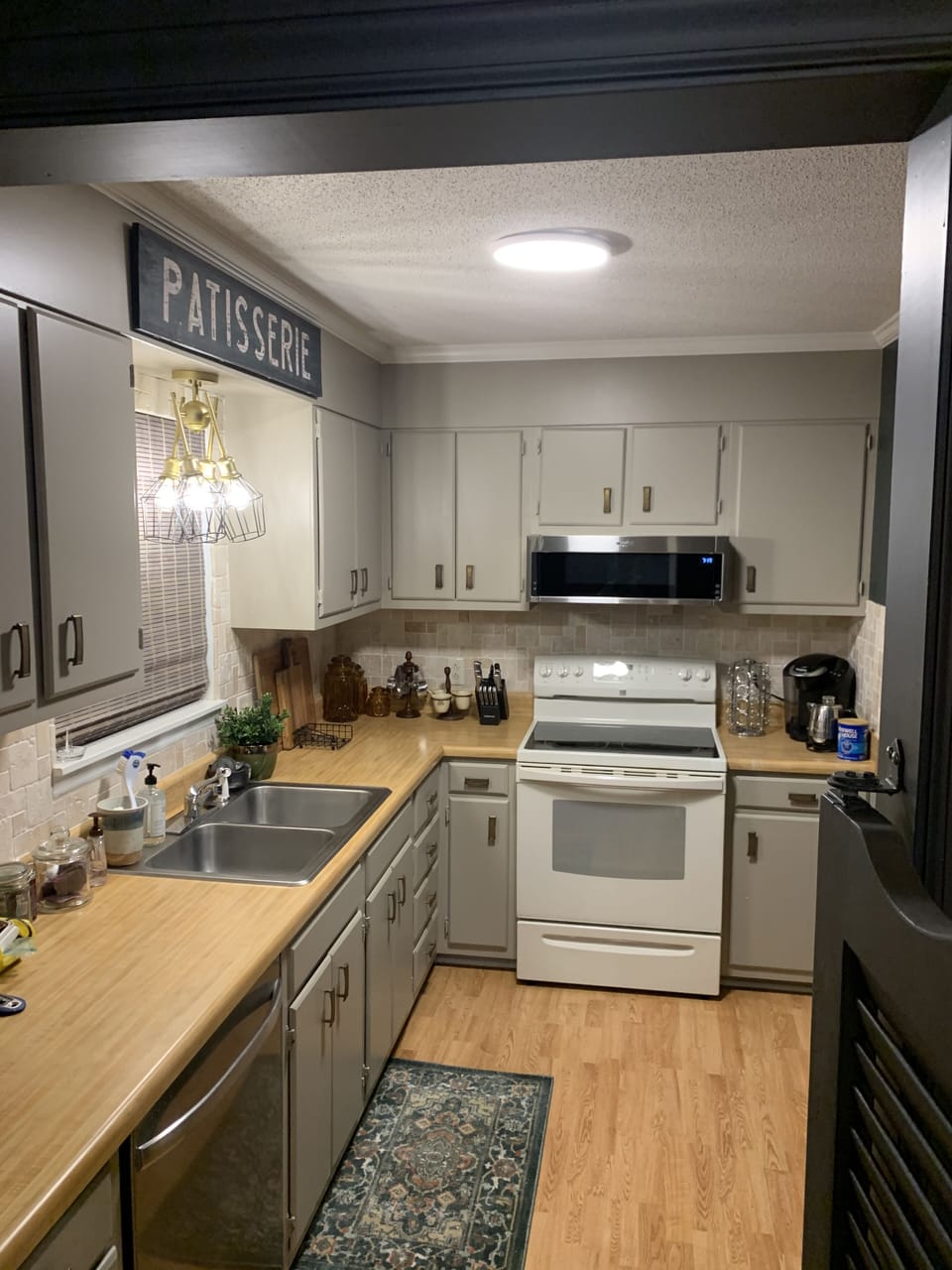 Galley kitchen fully equipped with pots and utensils. 