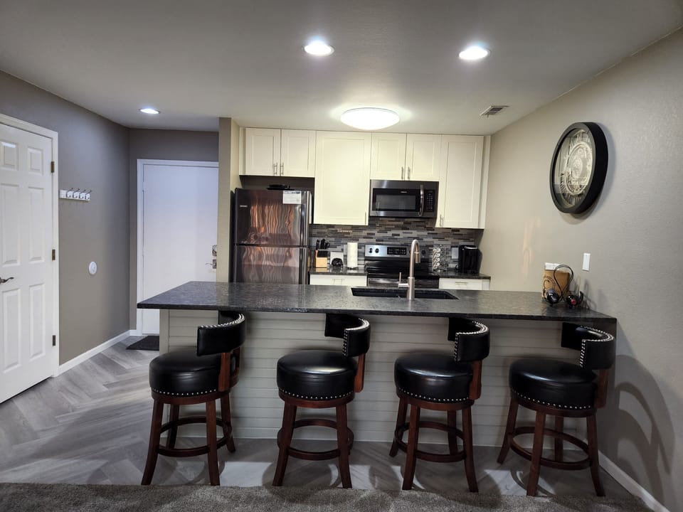 Slate stainless steel appliances with a glass back splash.