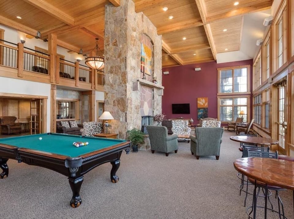 Grand room with pool table and fireplace