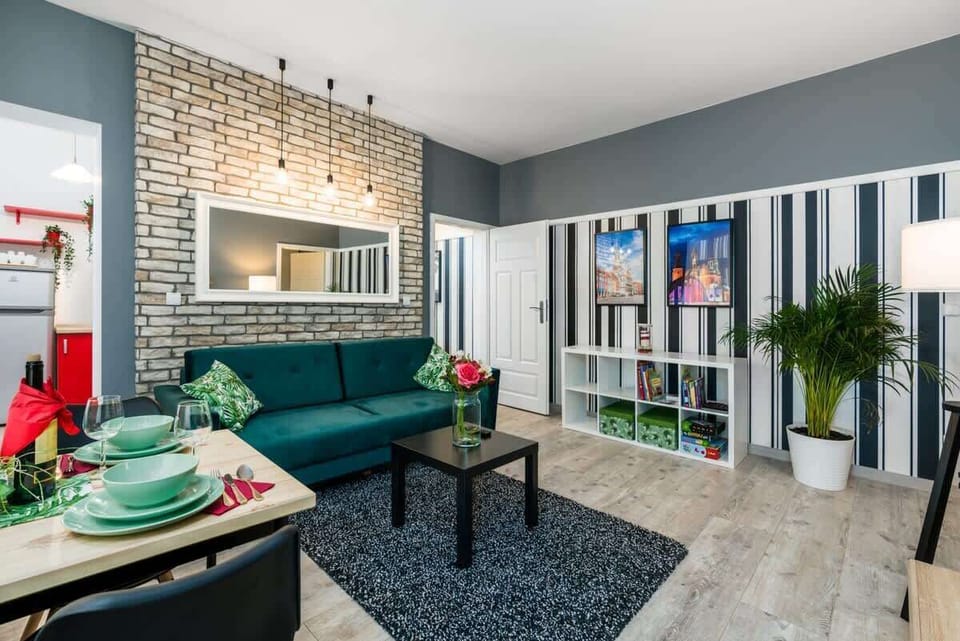 The elegant living room featuring a comfortable emerald sofa perfect for relaxation.