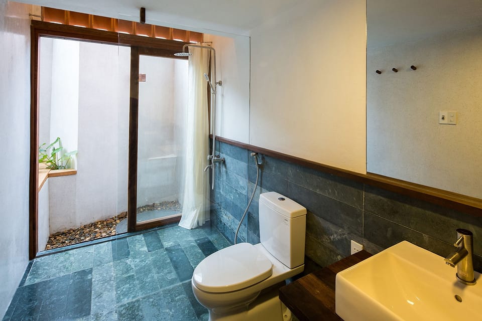 Family Studio | Bathroom | Shower, designer toiletries, hair dryer, slippers
