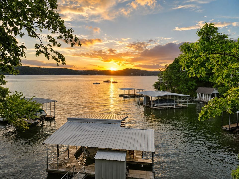 The elevated waterfront view looks across private docks and calm water toward a glowing golden-hour horizon.