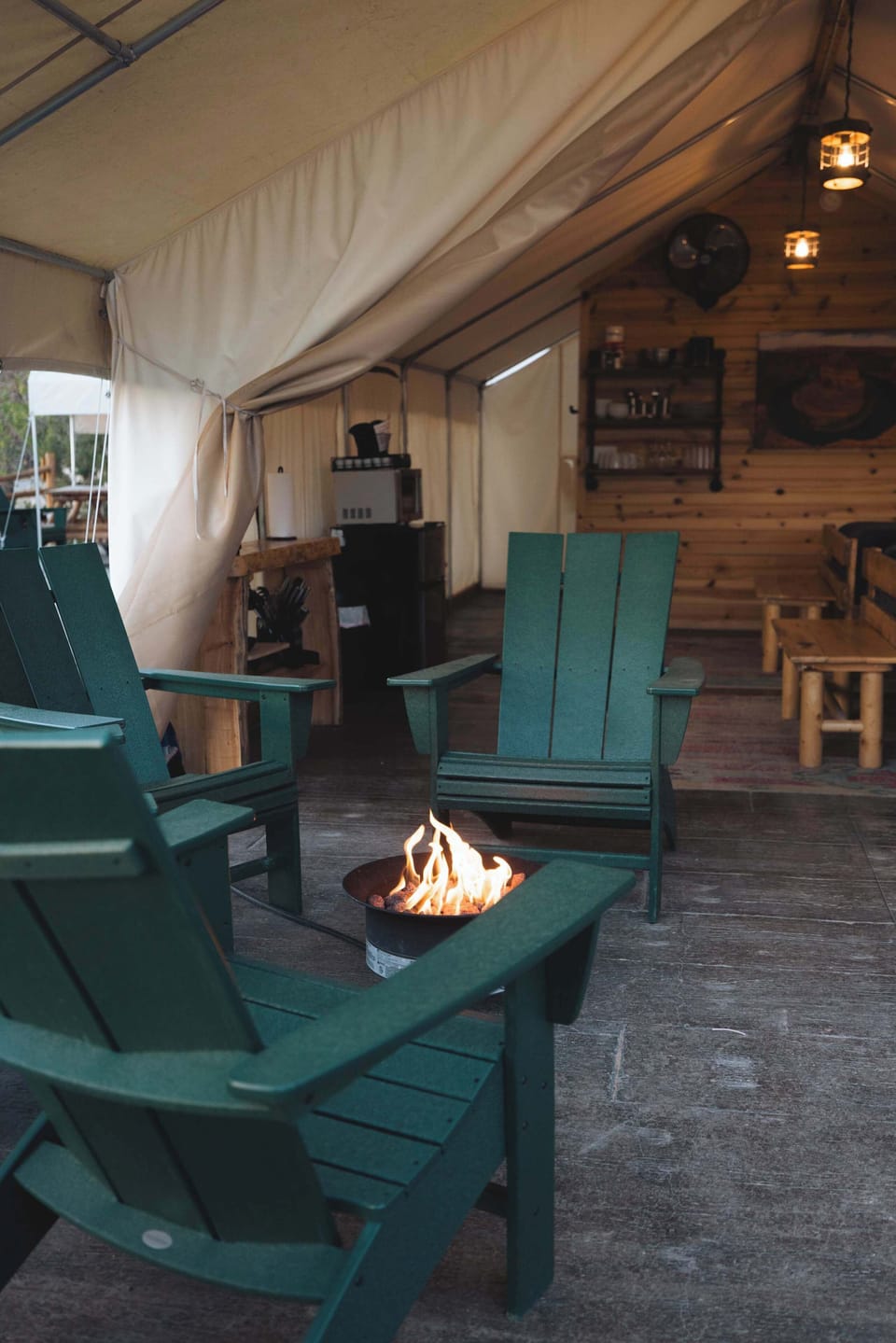 Covered patio at your glamping tent with outdoor seating, a fire pit, picnic table, and room to relax after a day exploring Zion National Park and Bryce Canyon.