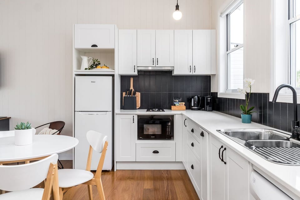 Kitchen with dishwasher and all plates, cooking utensils etc