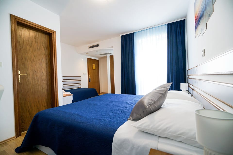 Triple Room, Balcony, Partial Sea View | In-room safe, desk, free WiFi, bed sheets