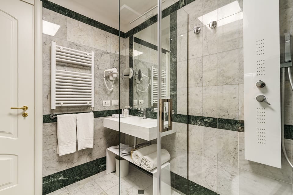 Deluxe Quadruple Room | Bathroom | Shower, rainfall showerhead, designer toiletries, hair dryer