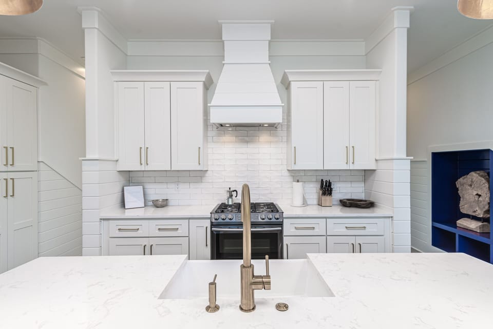 Gorgeous all white kitchen.  View from island barstools.