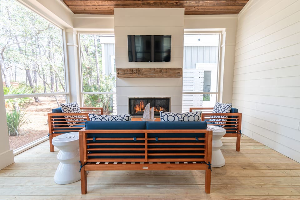 Our porch features a fireplace, TV, and exposed cypress wood beams ceiling 
