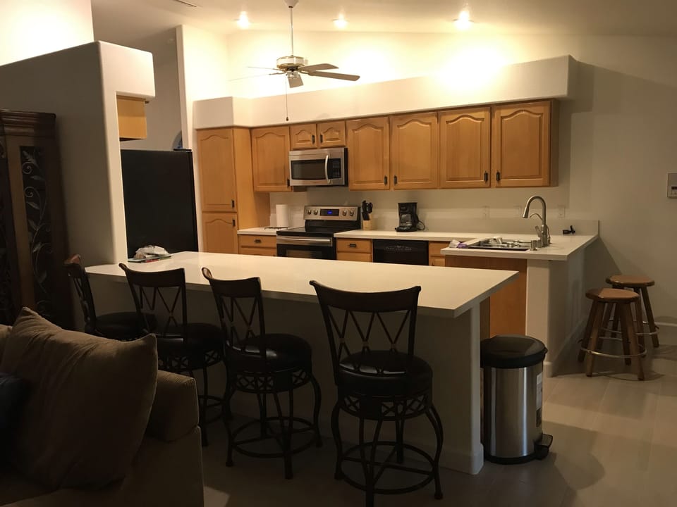 Kitchen with large peninsula with four bar stools  