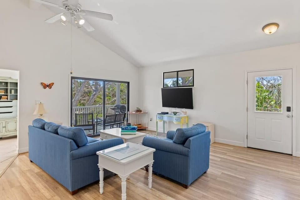 The living room features ample seating in front of the smart TV, ideal for kicking back and relaxing at the end of a beach day