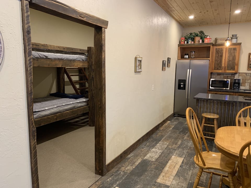 The bunkroom and kitchen from just inside the entrance.  A curtain for a door.