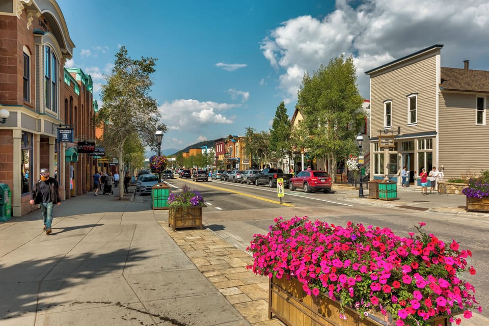 A charming downtown street scene featuring historic buildings, vibrant flower planters, and local shops, offering a glimpse into the community and walkable neighborhood near the property.