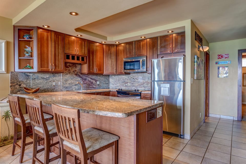 Upgraded kitchen with granite counter tops and back-splash
