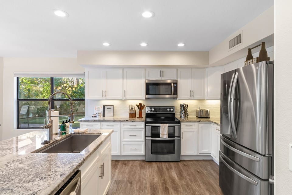 Fully Equipped Kitchen with Sleek Stainless Steel Appliances, Double Oven Range, and Well Stocked Chef's Kitchen
