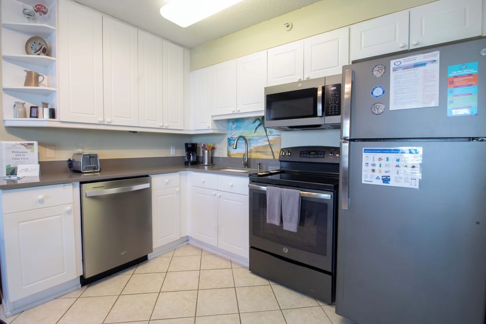 Your fully equipped kitchen invites you to whip up vacation meals with modern appliances, crisp white cabinetry, and plenty of counter space for gathering around morning coffee.