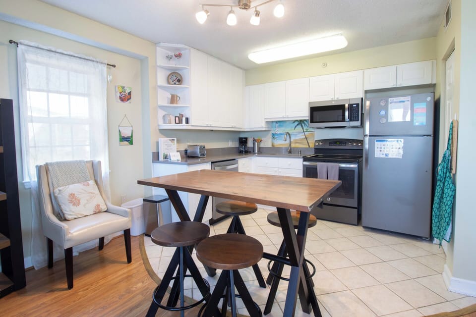 Step into your fully-equipped kitchen where you can prepare meals at the island, sip coffee by the window, or gather around the table to plan your day's adventures together.
