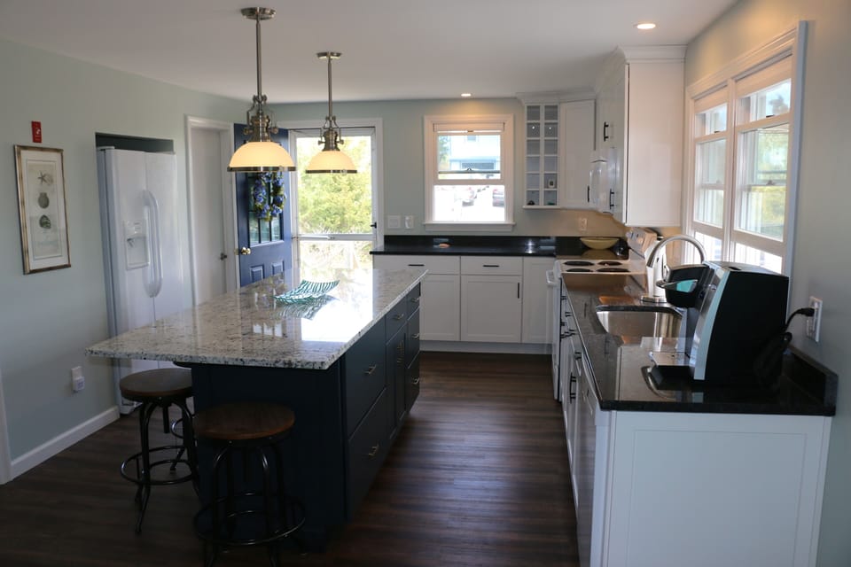 Kitchen with amenities and spacious granite island.
