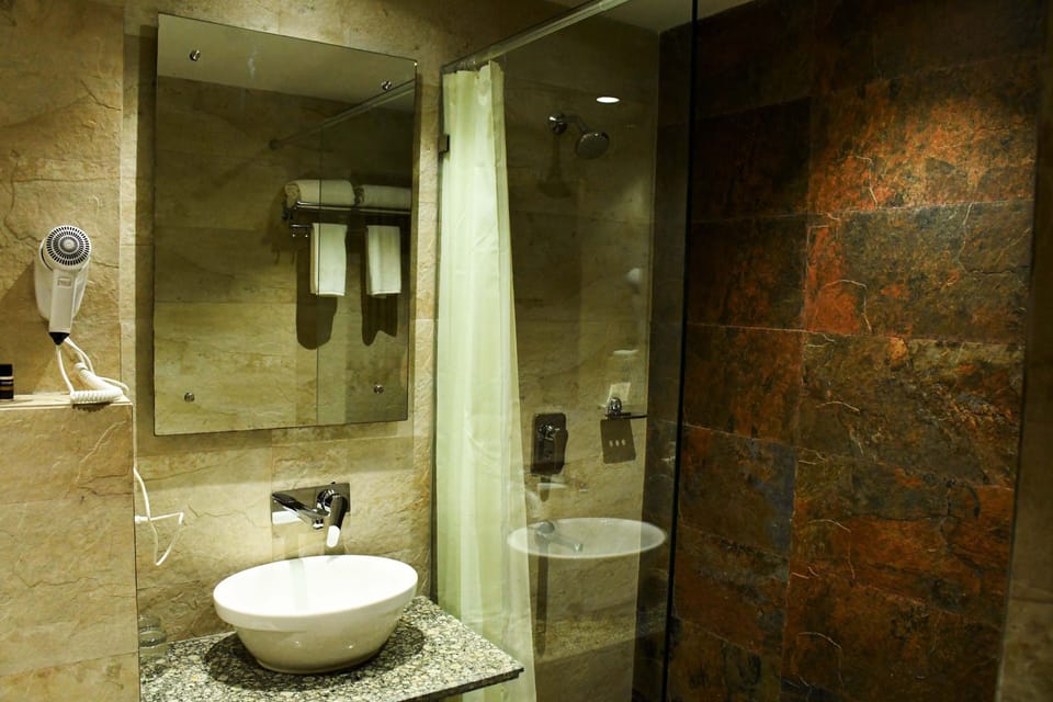 Deluxe Room | Bathroom | Shower, hair dryer, slippers, towels