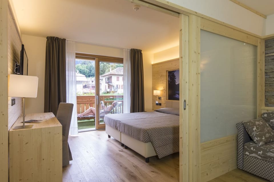 Junior Quadruple Room | 1 bedroom, down comforters, minibar, in-room safe