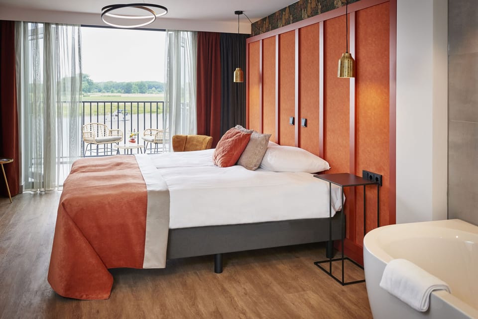 Deluxe Double Room | Minibar, in-room safe, desk, blackout drapes