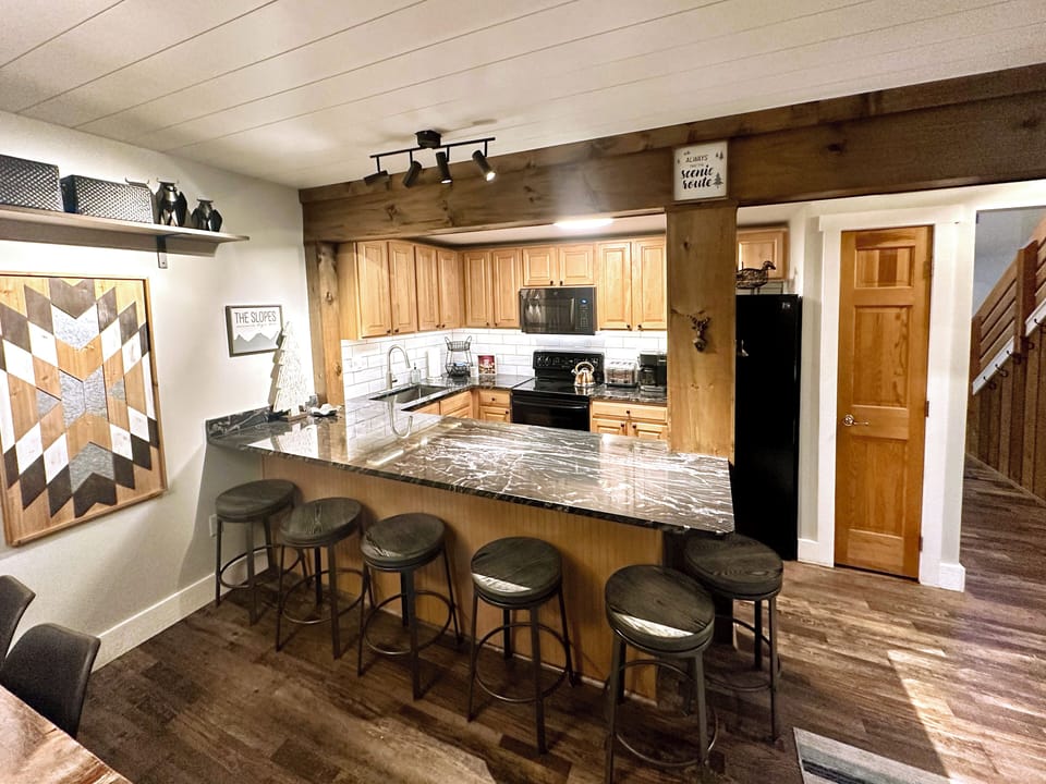 Kitchen boasts maple cabinets, backsplash, granite counters & new appliances.