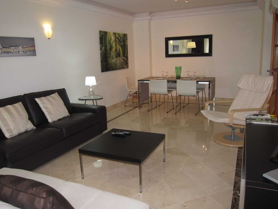 Livingroom with a tv area and a dining area. It has both a/c and heater.