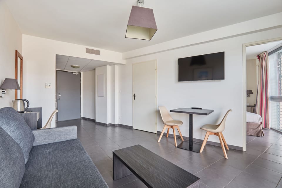 Embrace serene moments in this beautifully designed living area, equipped with a flat-screen TV and comfortable seating, inviting you to unwind after a day of exploring.