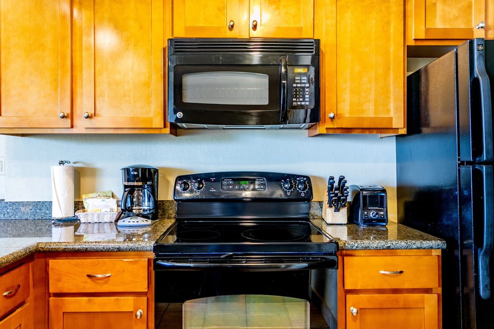 Your fully equipped kitchen features modern appliances including a stove, microwave, coffee maker, and toaster—everything you need to prepare delicious meals during your stay.