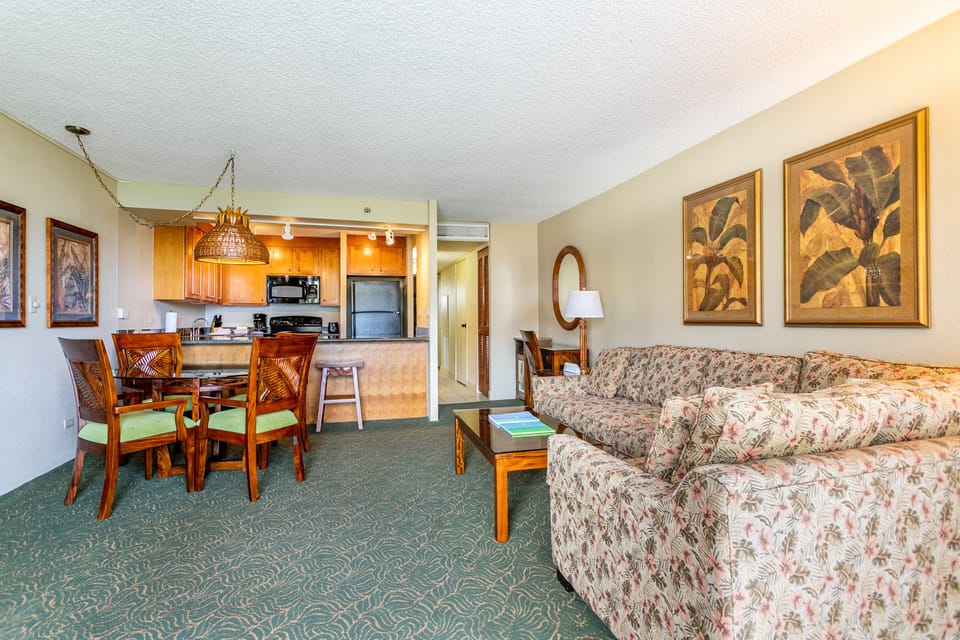 Your spacious living room flows seamlessly into a fully equipped kitchen, inviting you to relax on the comfy couch or gather around the dining table for meals together.
