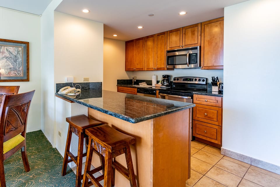 Your well-appointed kitchen features granite countertops, modern appliances, and a convenient breakfast bar—perfect for morning coffee or casual meals during your stay.