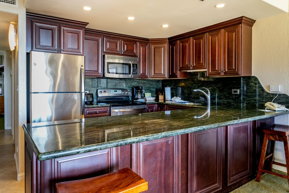 Your fully-equipped kitchen features rich cherry cabinets, granite countertops, stainless steel appliances, and everything you need to prepare meals like you're at home.