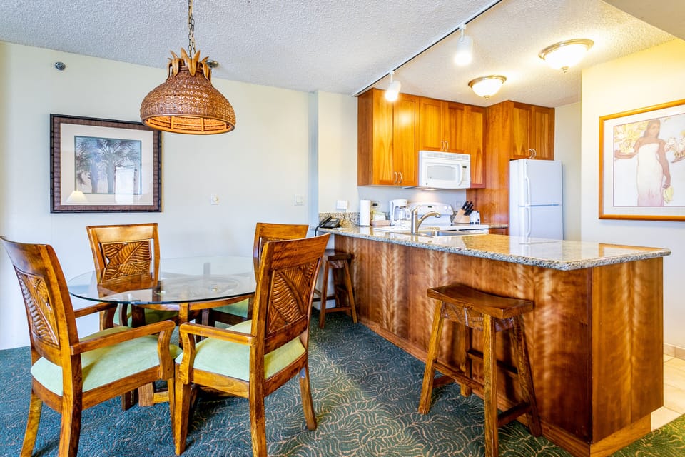 Gather around the warm tropical wood dining table or enjoy casual meals at your breakfast bar, with a fully equipped kitchen ready for your island culinary adventures.