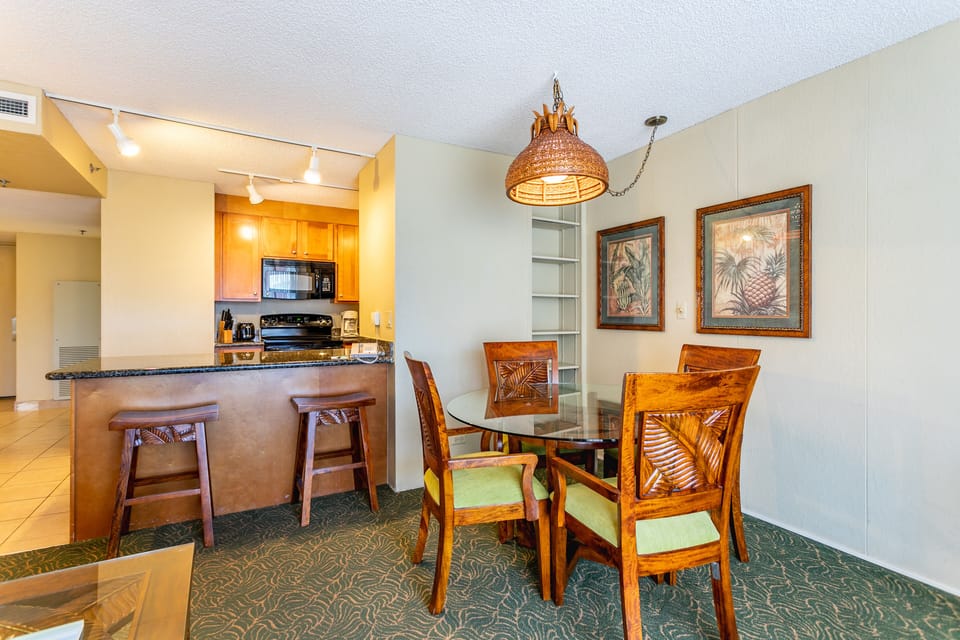 Gather around this tropical-themed dining table for meals together, with a fully equipped kitchen just steps away for your convenience.