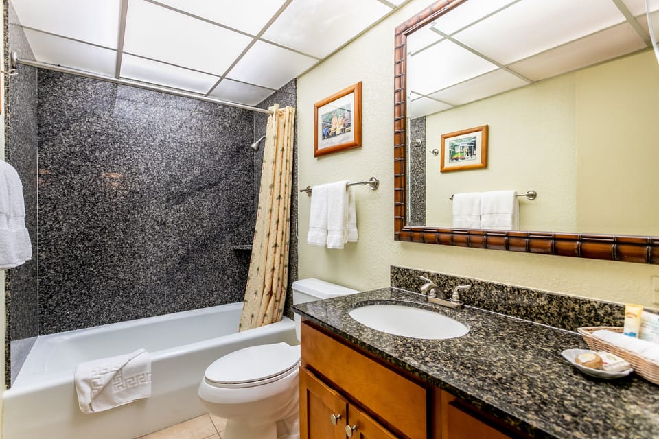 Freshen up in your private bathroom, complete with a granite vanity, a full tub-and-shower combo, and fresh towels awaiting your arrival.
