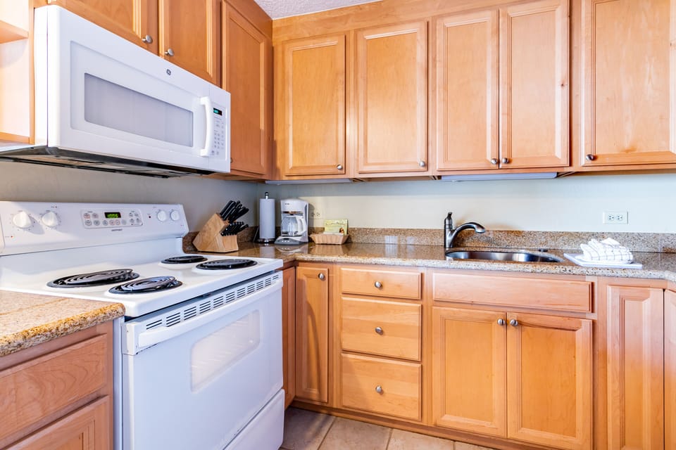 Prepare your favorite meals in this well-appointed kitchen featuring granite countertops, full-sized appliances, and all the essentials for your stay.