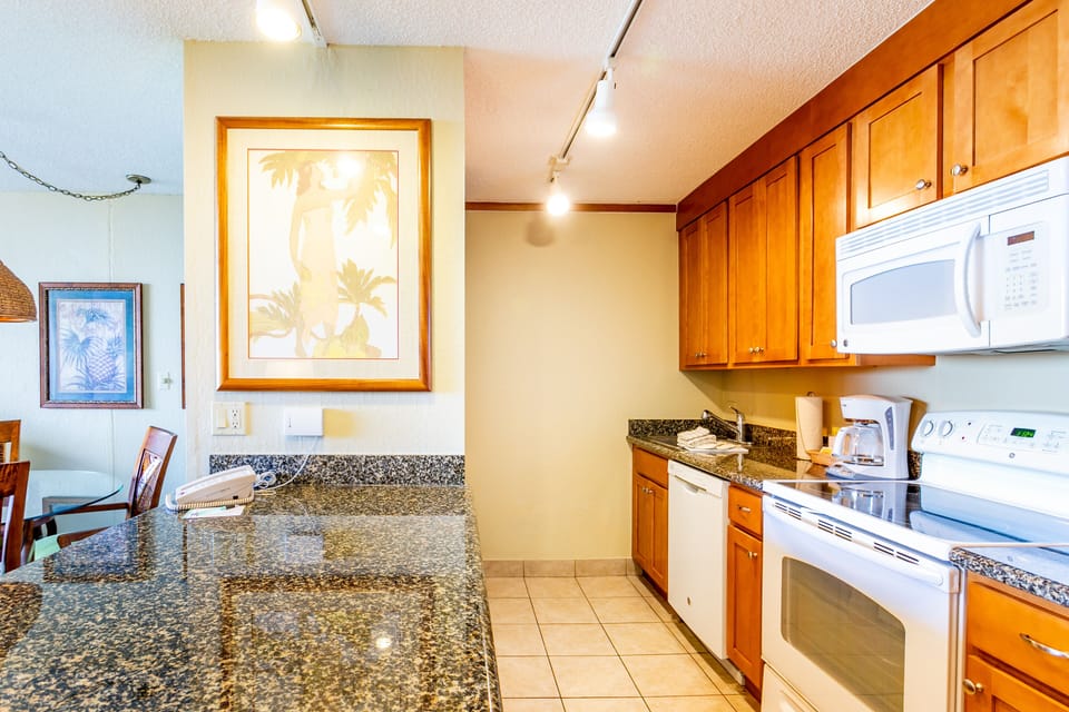 Your fully equipped kitchen features granite countertops, warm wood cabinetry, and all the appliances you need to prepare meals at your leisure during your stay.
